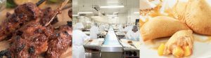 Team members in a commercial-grade kitchen assembling gourmet food trays during a co‑packing production run.